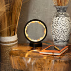 Glowing rose quartz halo lamp on a table
