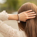 Bracelets worn together, viewed from behind