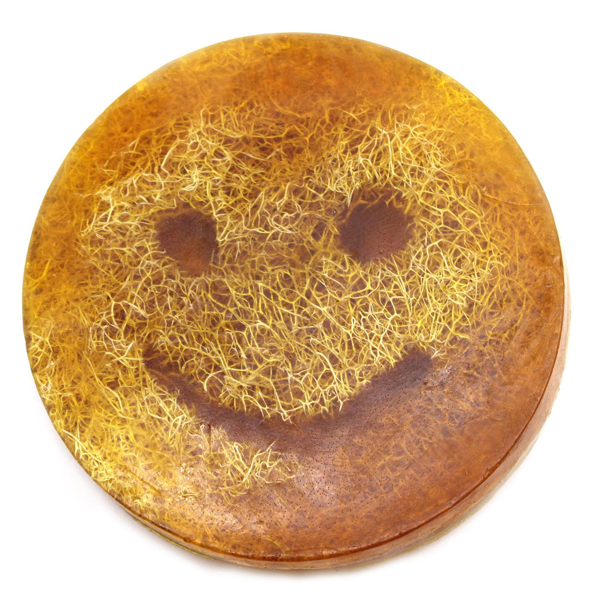 Close-up of an orange-brown round Happy Scrub Soap with a smiley face against a white background