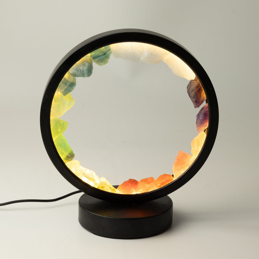 Gemstone halo lamp lit, showing its colourful stone ring and black frame