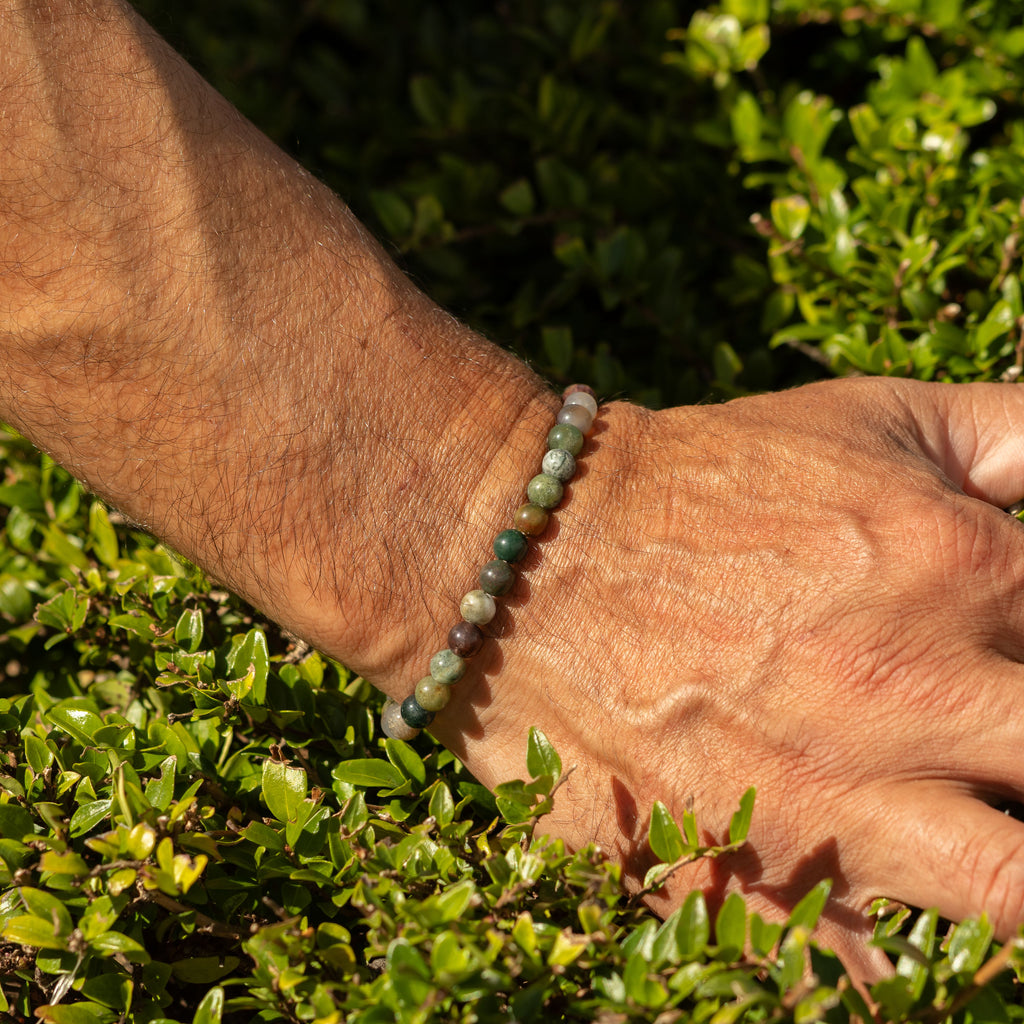 Moss Agate bracelet shown on a wrist outdoors