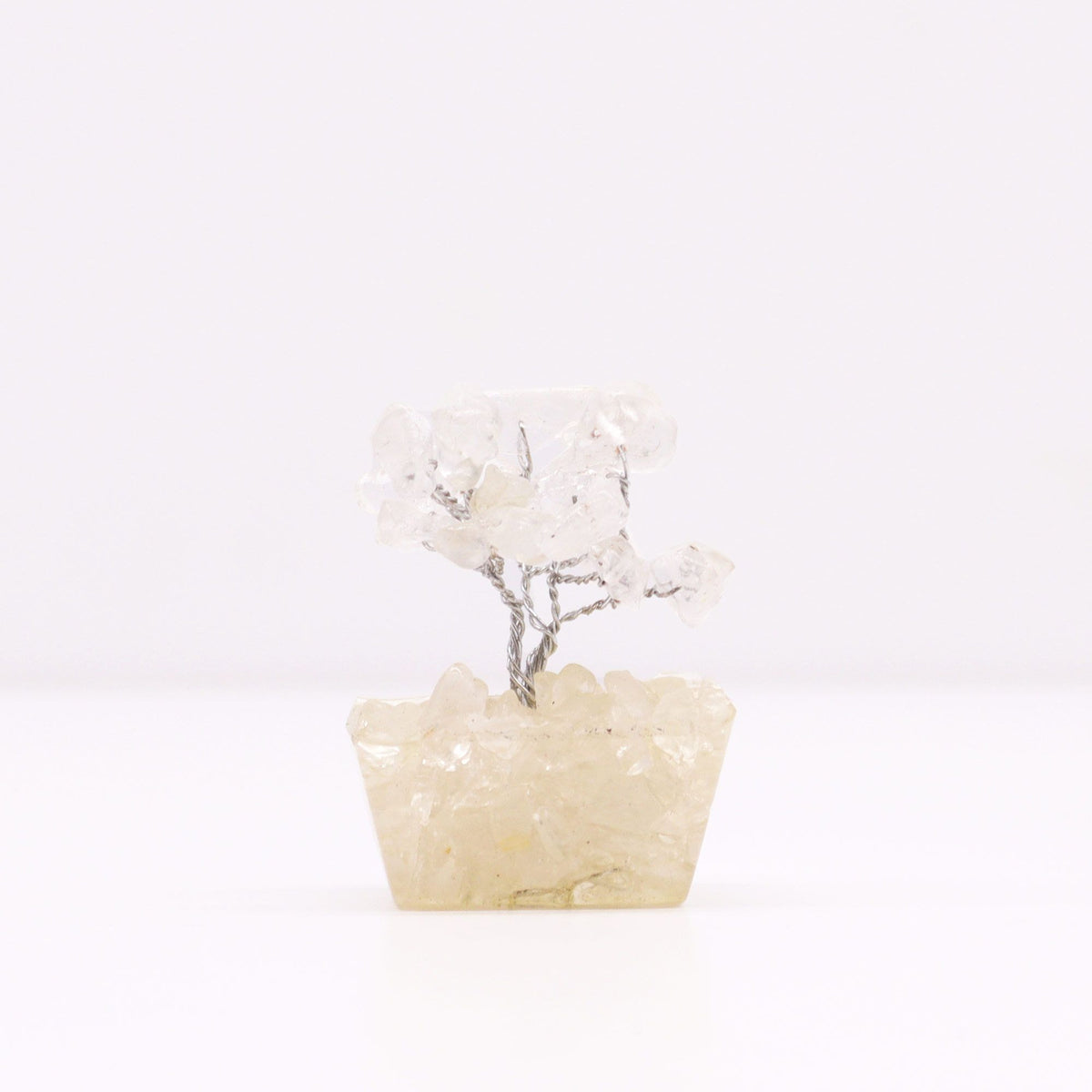Single rock quartz gemstone tree shown from the front against a plain pale background