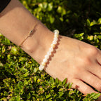 Bracelet worn beside a fine gold-coloured chain bracelet
