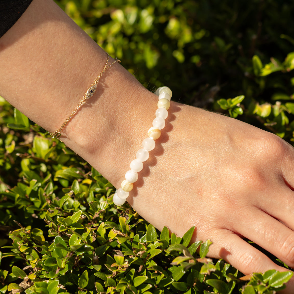 Bracelet worn beside a fine gold-coloured chain bracelet