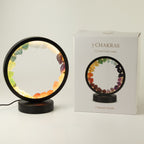 Lit gemstone halo lamp beside its product box