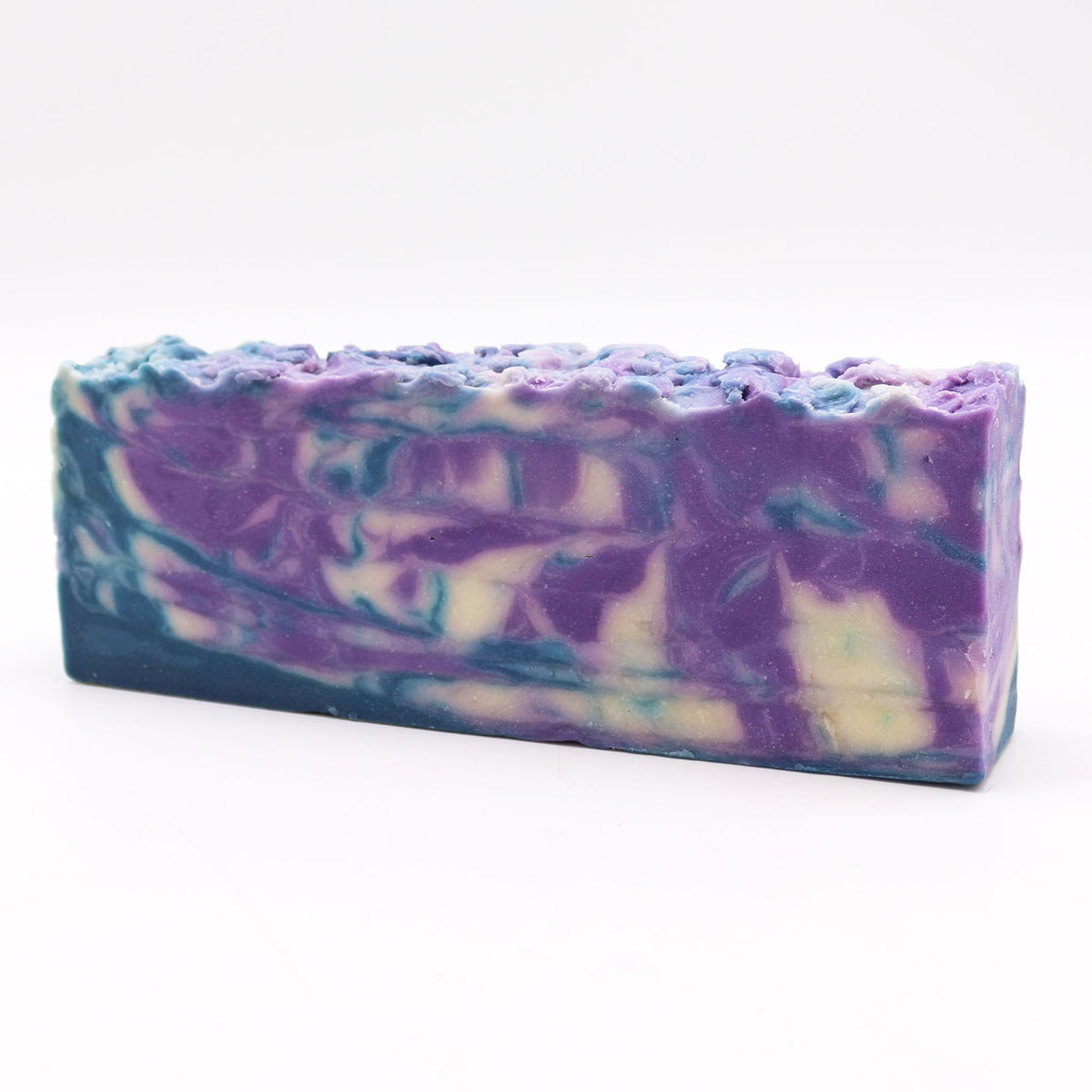 Herb of Grace, Olive Oil Soap Loaf, purple, teal and cream marbled bar shown from the front on white