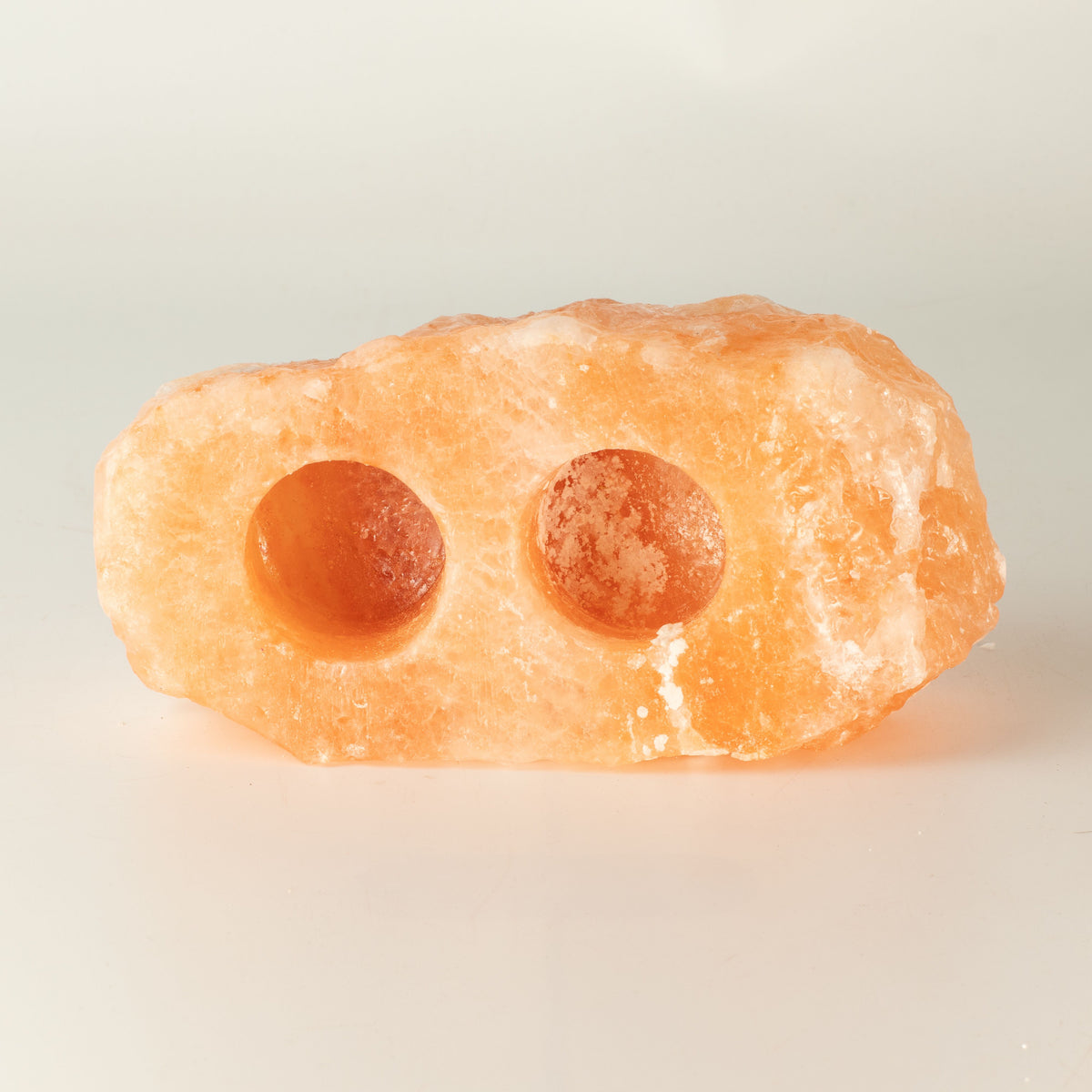 Natural Salt Candle Holder, 2 holes, glowing orange holder shown from the front on a plain background