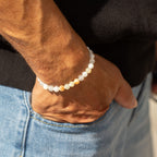 Bracelet worn on a wrist above jeans