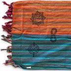 Scarf laid flat showing contrasting colour sections and printed symbols