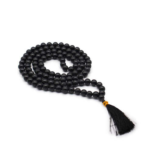 108 Bead Mala, Black Agate, coiled black beads with a black tassel on a plain white background