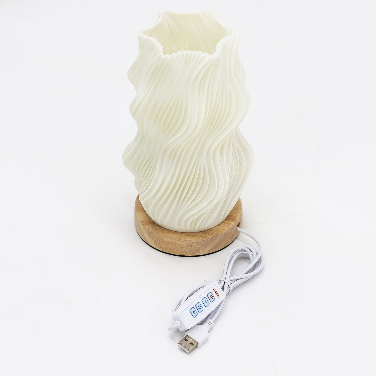 Star Twisted lamp viewed from above, with its USB cable and inline control on a white surface