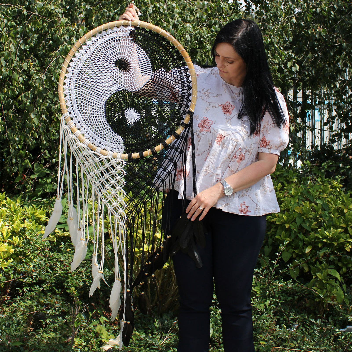 Bali Dream Catchers, Extra Large Ying Yang D: 50cm, held outdoors by a woman, front view