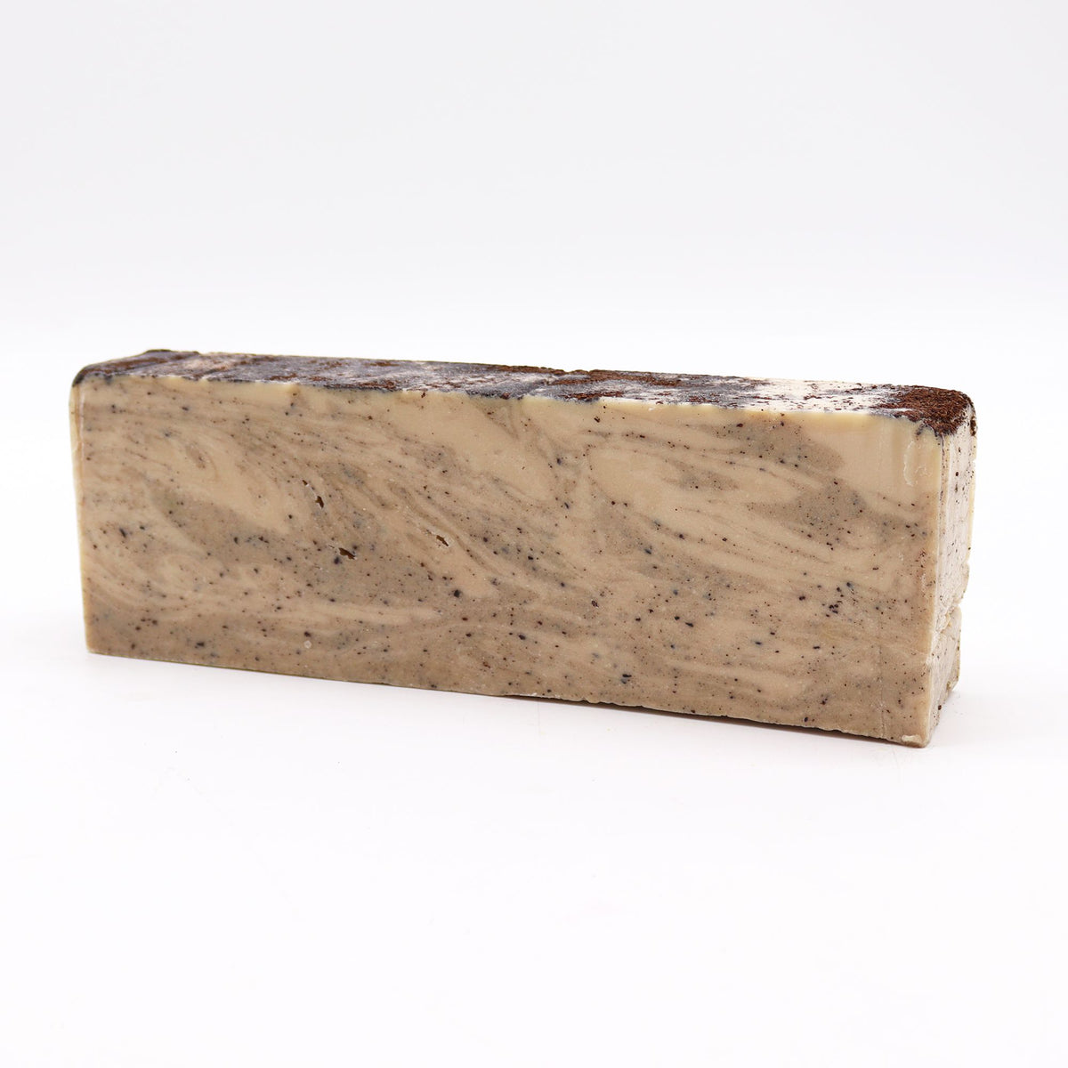 Coconut, Olive Oil Soap Loaf, a long beige bar with dark speckles and swirls, shown alone from the front