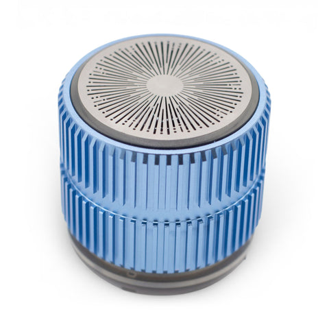 Mint Rock Mini Speaker, blue ridged cylinder with a silver radial grille, shown from above on white