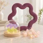 Mauve velvet star mirror with a glass dome of lit purple tulips and a string of glowing rose quartz lights