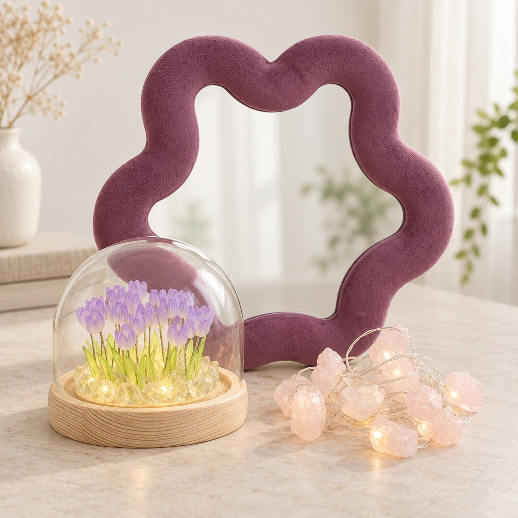 Mauve velvet star mirror with a glass dome of lit purple tulips and a string of glowing rose quartz lights